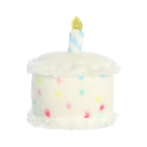 The Twice as Sweet Palm Pal Happy Bday Cake is a plush toy shaped like a cake, featuring white fuzzy frosting, colorful polka dots, and a blue-and-white striped candle with a yellow flame.