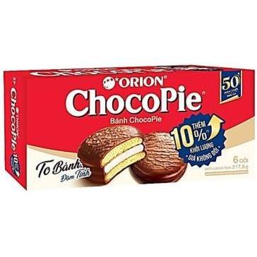 A red and white box of Twice as Sweet Orion Choco Pie Original (Vietnam) shows chocolate-covered marshmallow pies with creamy filling. The Vietnamese text highlights “10% thêm khối lượng.” The box contains six pies.