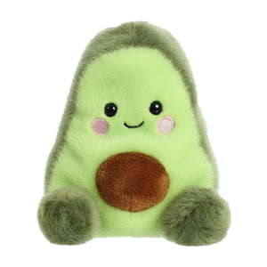 Meet the Twice as Sweet Palm Pal Airy Avocado, a collectible plush with a light green body, brown pit, fluffy dark green sides, smiling face, and pink cheeks—ideal for any foodie plush collection!.