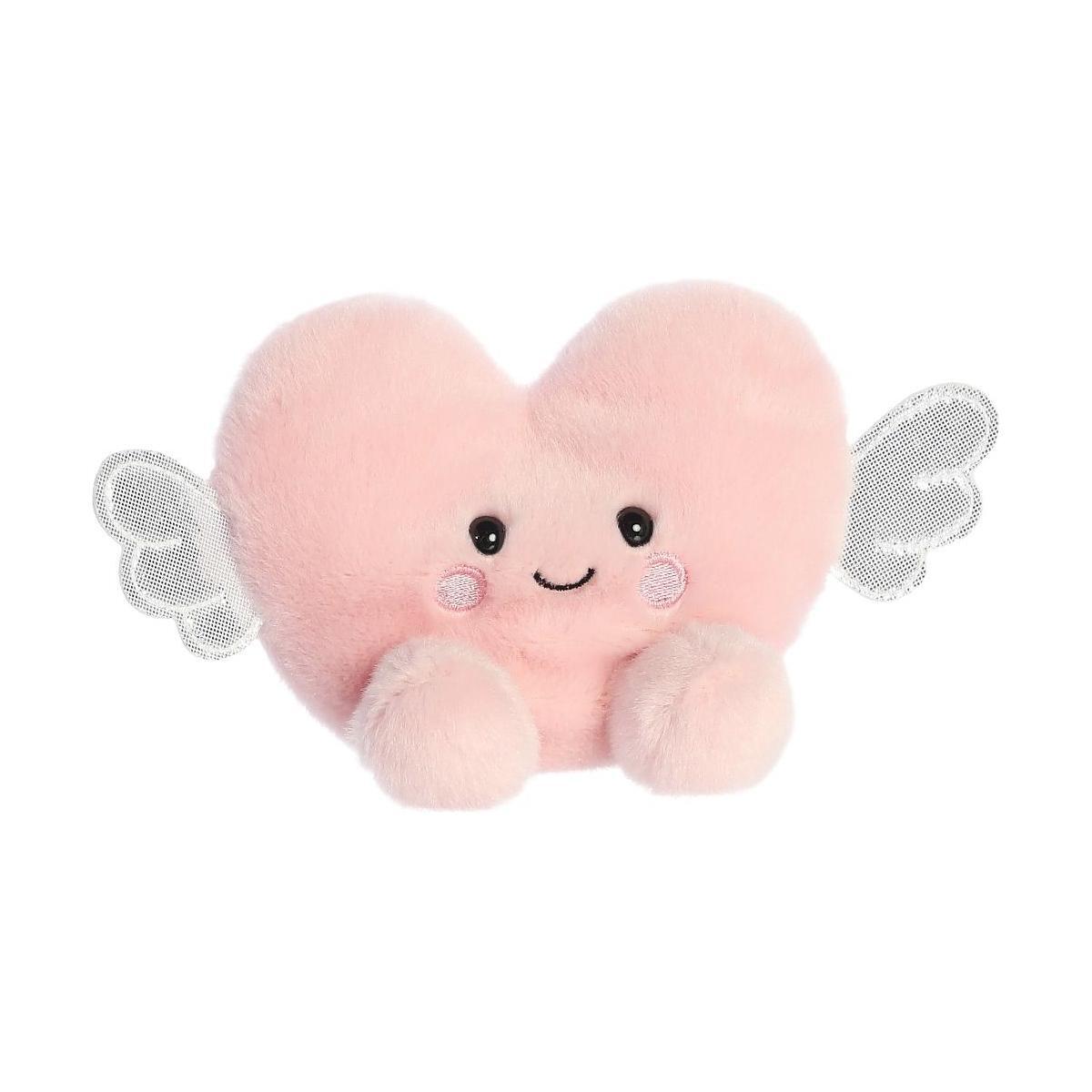 The Twice as Sweet Palm Pal Bliss Heart is a plush pink heart-shaped toy with a smiling face, blushing cheeks, small arms, and silver wings—perfect for Valentine’s Day—shown against a white background.