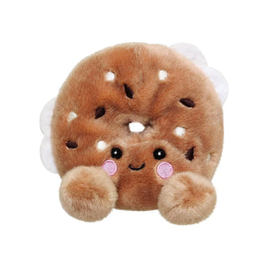 Palm Pal Tony Everything Bagel by Twice as Sweet is a plush toy styled as an everything bagel with a cute embroidered face, pink cheeks, and fluffy paws—perfect for adding charm to any collection. Background is plain white.