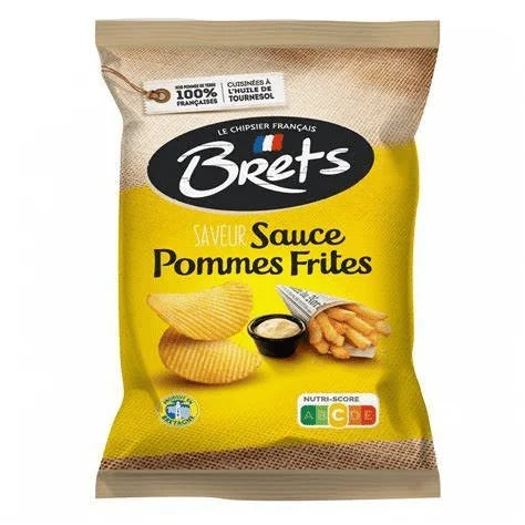 A yellow and brown 125g bag of Twice as Sweet Brets Pommes Frites Sauce Chips from France, featuring ridged chips, fries, dipping sauce, a French flag, and a Nutri-Score label.