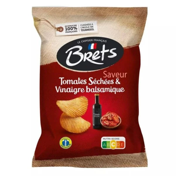 A 125g bag of Twice as Sweet Brets Sun-Dried Tomato and Balsamic Vinegar Chips (France), featuring wavy chips, a vinegar bottle, and sun-dried tomatoes on red and beige packaging with French text and a Nutri-Score label.