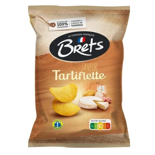 Brets Tartiflette Chips 125g (France) by Twice as Sweet features ridged French chips with cheese, potatoes, and bacon. The packaging displays French text and a nutri-score label, shown on a wooden surface.