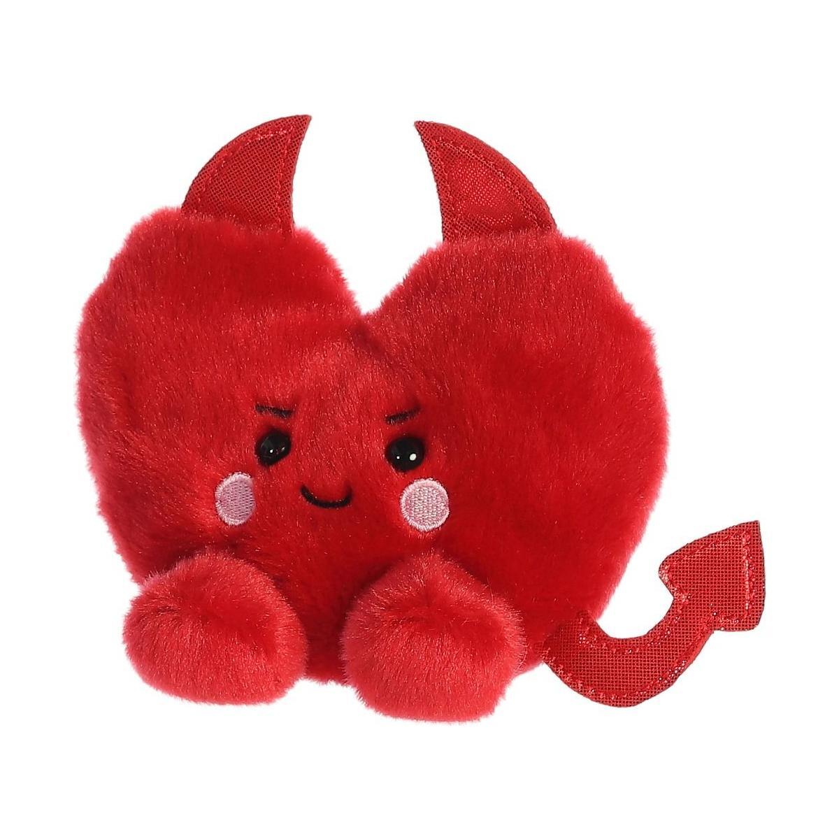 The Palm Pal Klaus Heart by Twice as Sweet is a plush red heart with devil horns, a smiling face, rosy cheeks, and a pointed tail—making it the perfect Valentines Day gift for someone special.