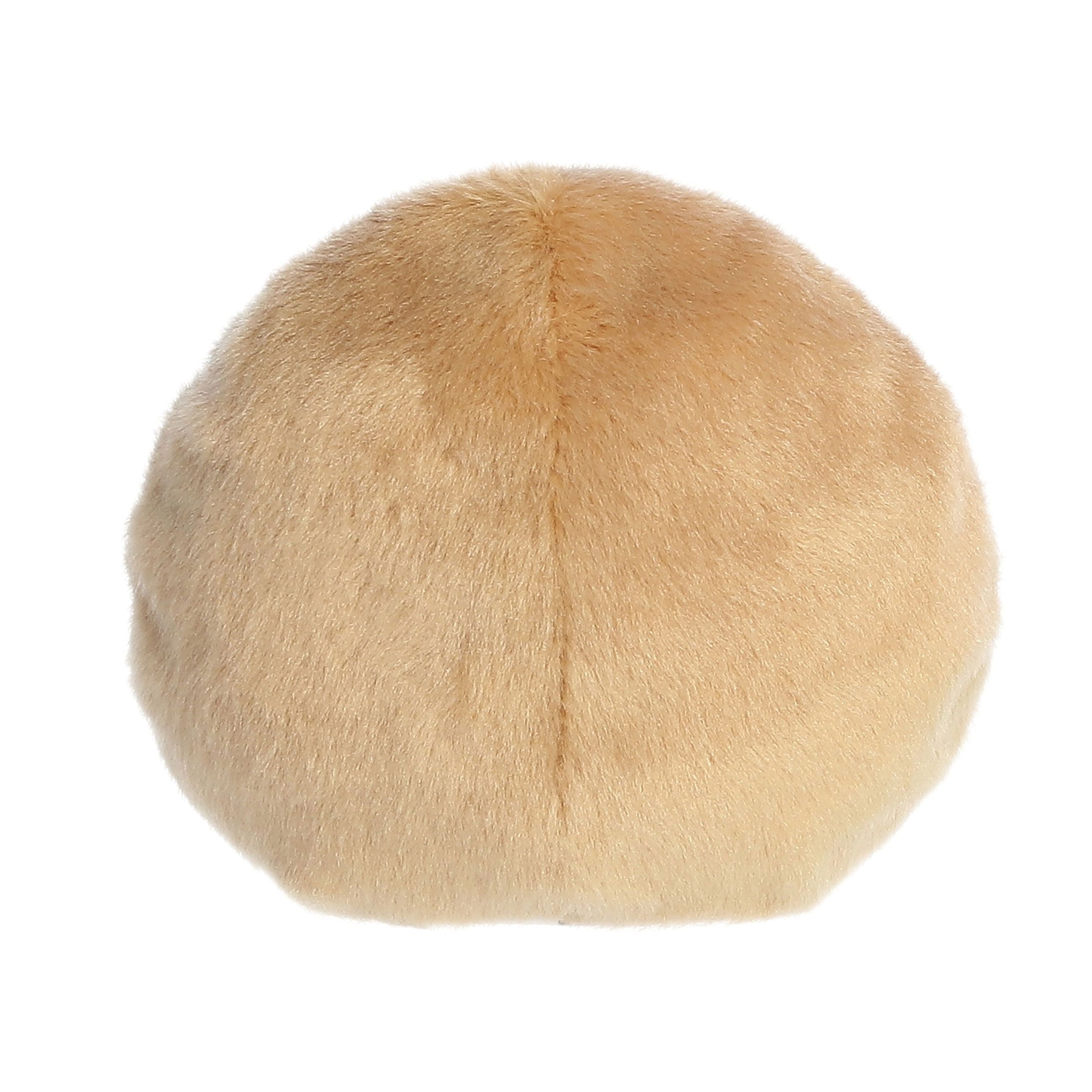 The Twice as Sweet Palm Pal Claire Donut is a round, beige plush toy with a furry texture, resembling a sweet treat, displayed against a white background.
