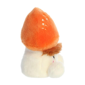 The Twice as Sweet Palm Pal Fabian Fluffy Mushroom is a soft plush toy with an orange cap, white stem, and pink blush. Its angled pose adds charm to whimsical parties or cozy spaces.