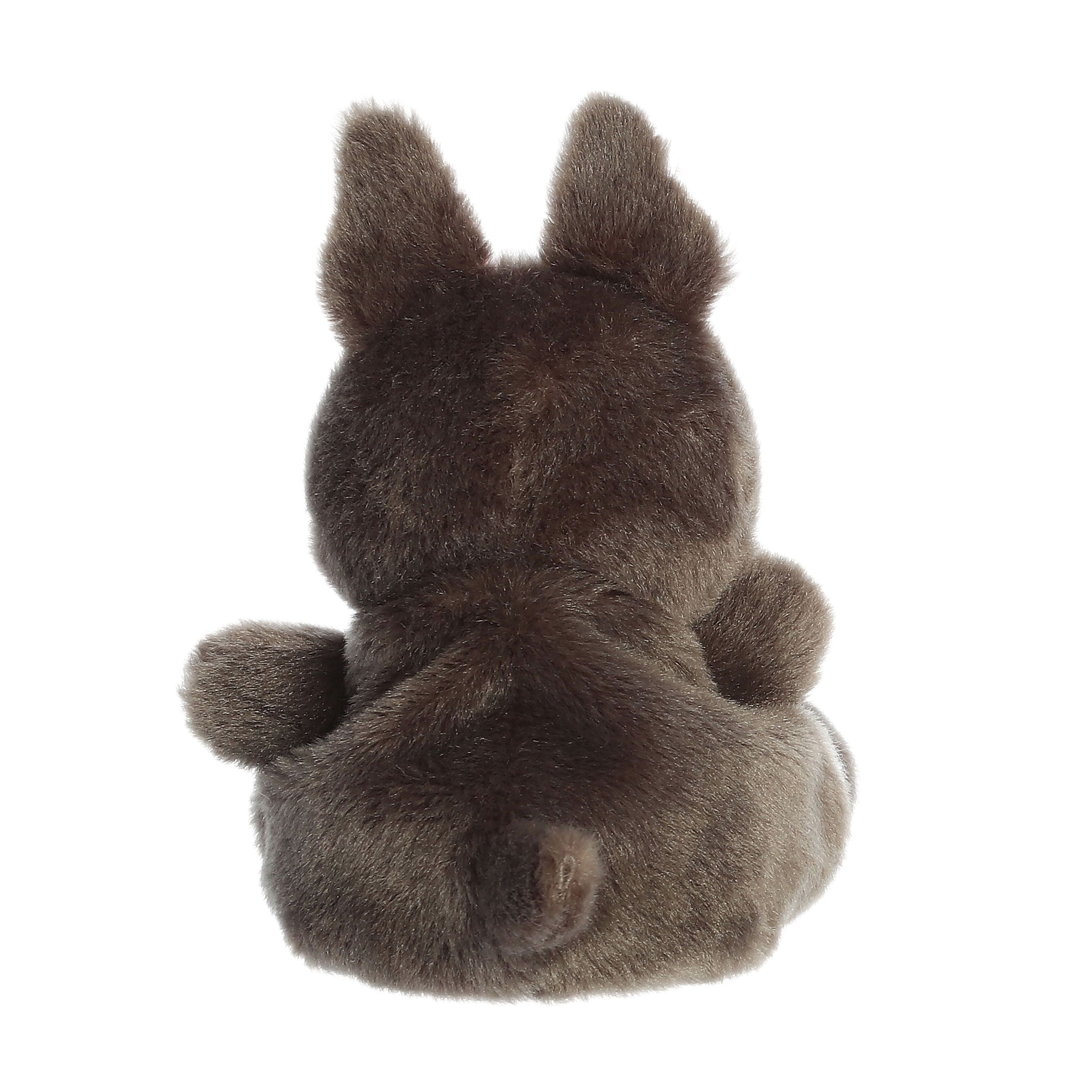 The Twice as Sweet Palm Pal Beau French Bulldog is a palm-sized stuffed animal seen from the back, featuring dark brown fur, upright ears, a short tail, and a round body while lying on its stomach.