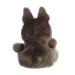 The Twice as Sweet Palm Pal Beau French Bulldog is a palm-sized stuffed animal seen from the back, featuring dark brown fur, upright ears, a short tail, and a round body while lying on its stomach.