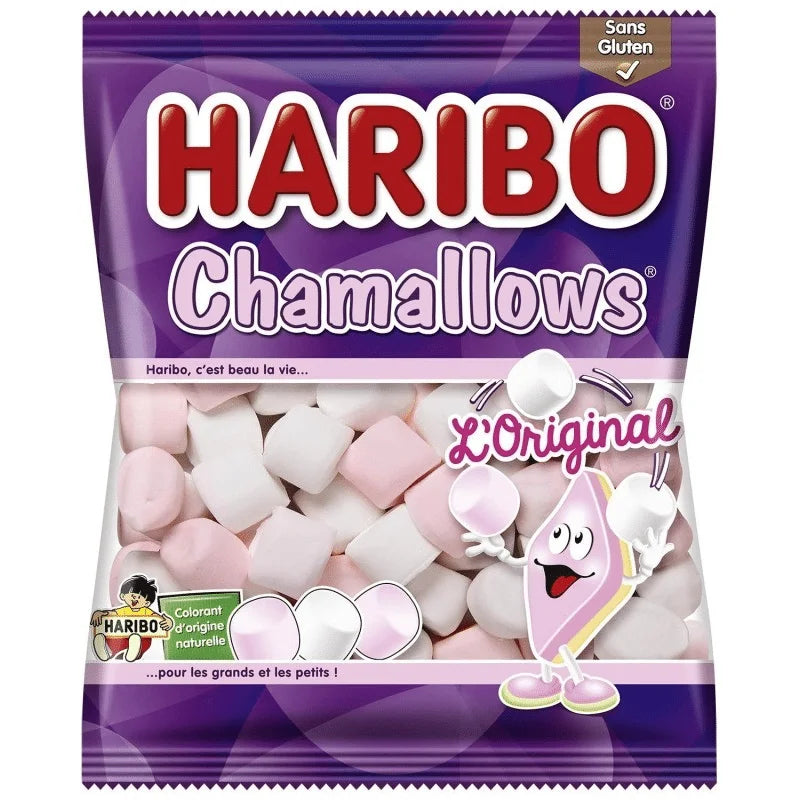 A 100g purple bag of Twice as Sweet Haribo Chamallows from France, featuring pink and white vanilla marshmallows, a smiling marshmallow on the pack, labeled LOriginal and gluten-free.