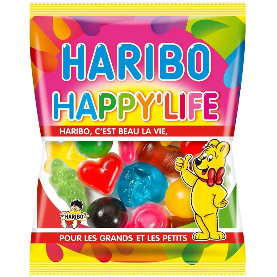 The Twice as Sweet Haribo Happy Life 120g (France) bag features fruity gummy candies in fun shapes, a yellow bear mascot, French text on the packaging, and a rainbow design across the top.
