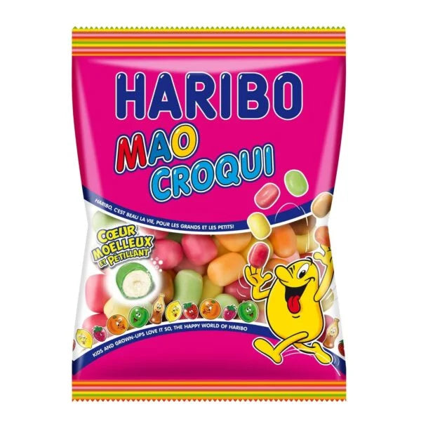 A colorful 250g package of Twice as Sweet Haribo Mao Croqui (France) features assorted chewy candies, a bright pink background, French text, and a cheerful yellow cartoon character—a tasty tropical fruit treat.