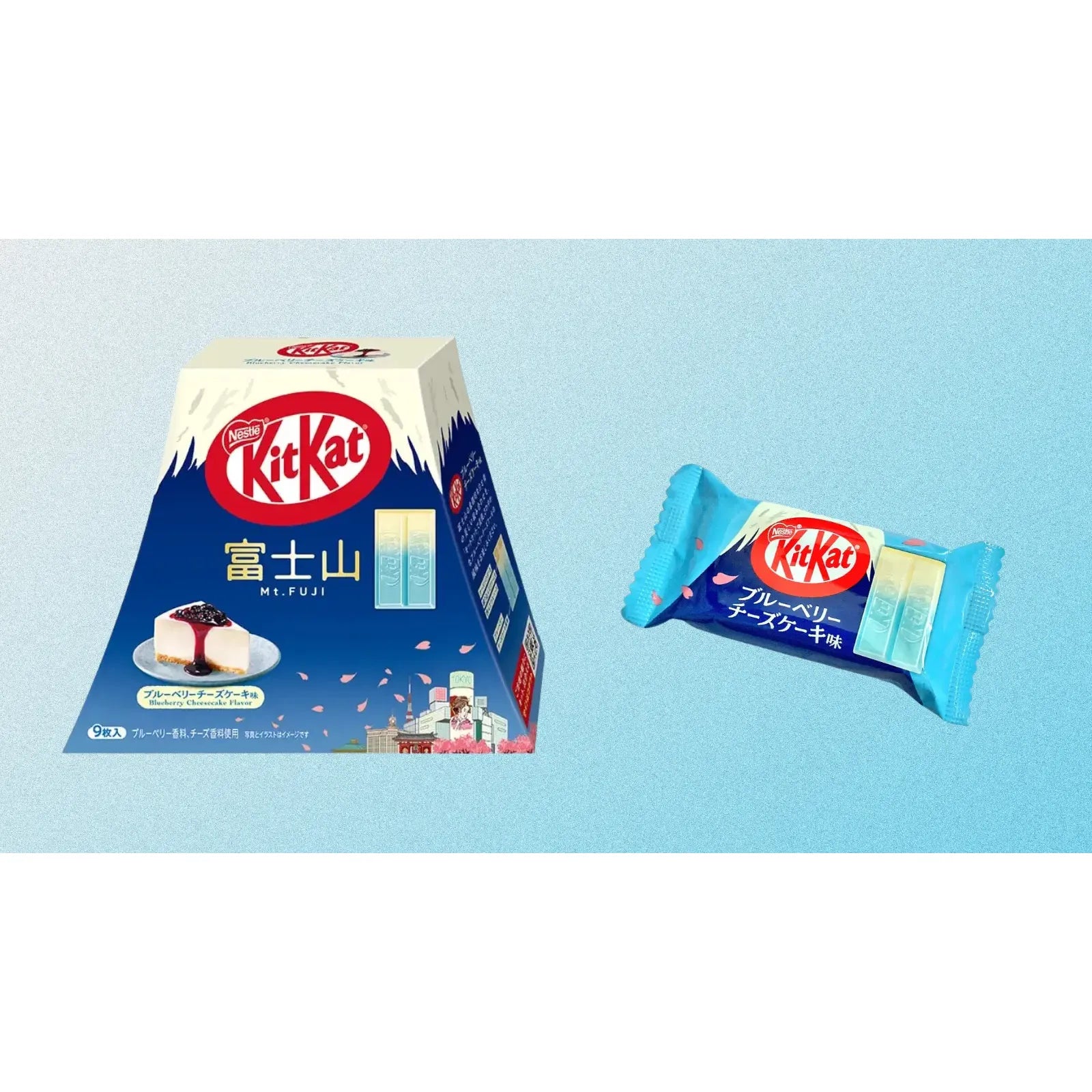 A Twice as Sweet KitKat Blueberry Cheesecake 9 Piece Box (Japan) and a blue individually wrapped bar, both labeled in Japanese, are shown against a light blue background.