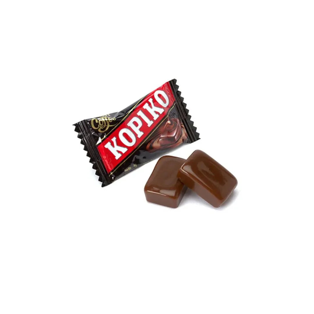 A black Twice as Sweet Kopiko Coffee Candy 150g (Indonesia) wrapper with two unwrapped, glossy brown candies displayed in front on a white background.