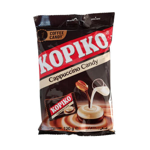 A 120g bag of Kopiko Cappuccino Candy (Indonesia) by Twice as Sweet, featuring creamy cappuccino flavor in brown and black packaging with the red and white KOPIKO logo, coffee candy image, coffee bean, and a milk pour.
