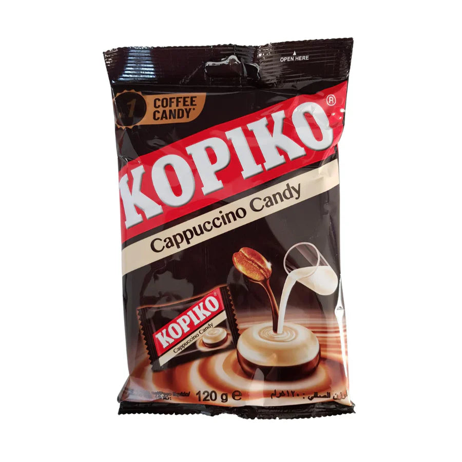 A 120g bag of Kopiko Cappuccino Candy (Indonesia) by Twice as Sweet, featuring creamy cappuccino flavor in brown and black packaging with the red and white KOPIKO logo, coffee candy image, coffee bean, and a milk pour.