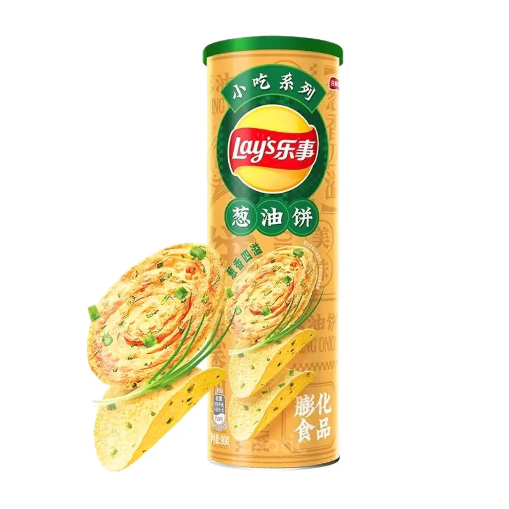 A yellow canister of Twice as Sweet Lay’s Scallion Pancake Flavour Chips 90g (China) with Chinese text, images of green onion pancakes, chips, and scallions evokes classic Chinese street food. The background is white.