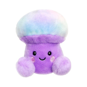 The Palm Pal Lunette Mushroom by Twice as Sweet is a whimsical plush toy with a pastel rainbow cap, soft purple body, blushing cheeks, and two fuzzy hands. It features a smiling mushroom design on a plain white background.