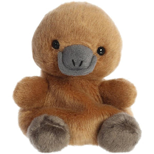 The Twice as Sweet Palm Pal Patty Platypus is a soft brown plush with a gray bill, round black eyes, and gray feet. This charming forest animal sits upright against a white background—perfect for all ages.