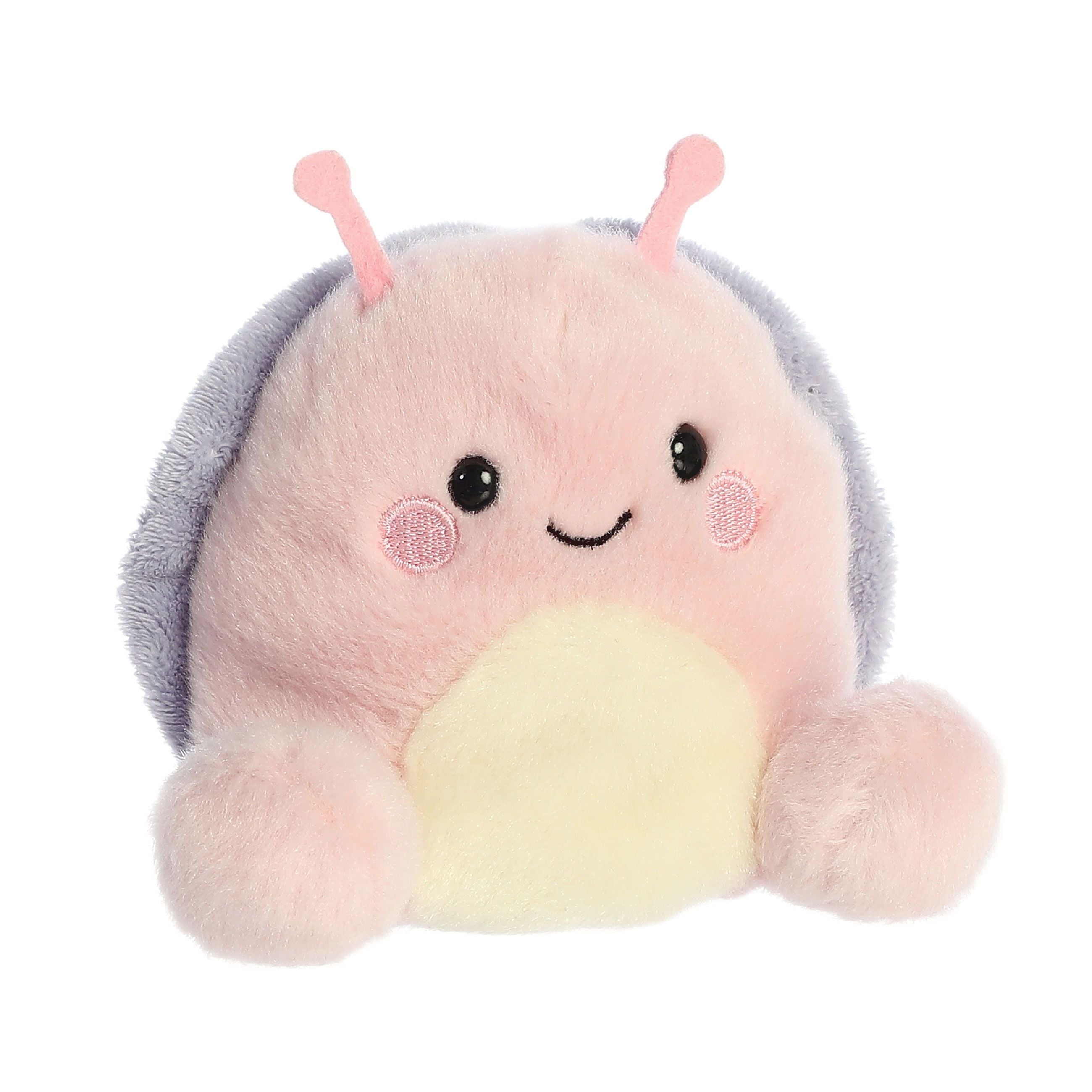 Palm Pal Shelby Snail by Twice as Sweet is a smiling plush snail with a pink face, rosy cheeks, yellow belly, pink antennae, and soft purple shell—a cute addition to any collection.