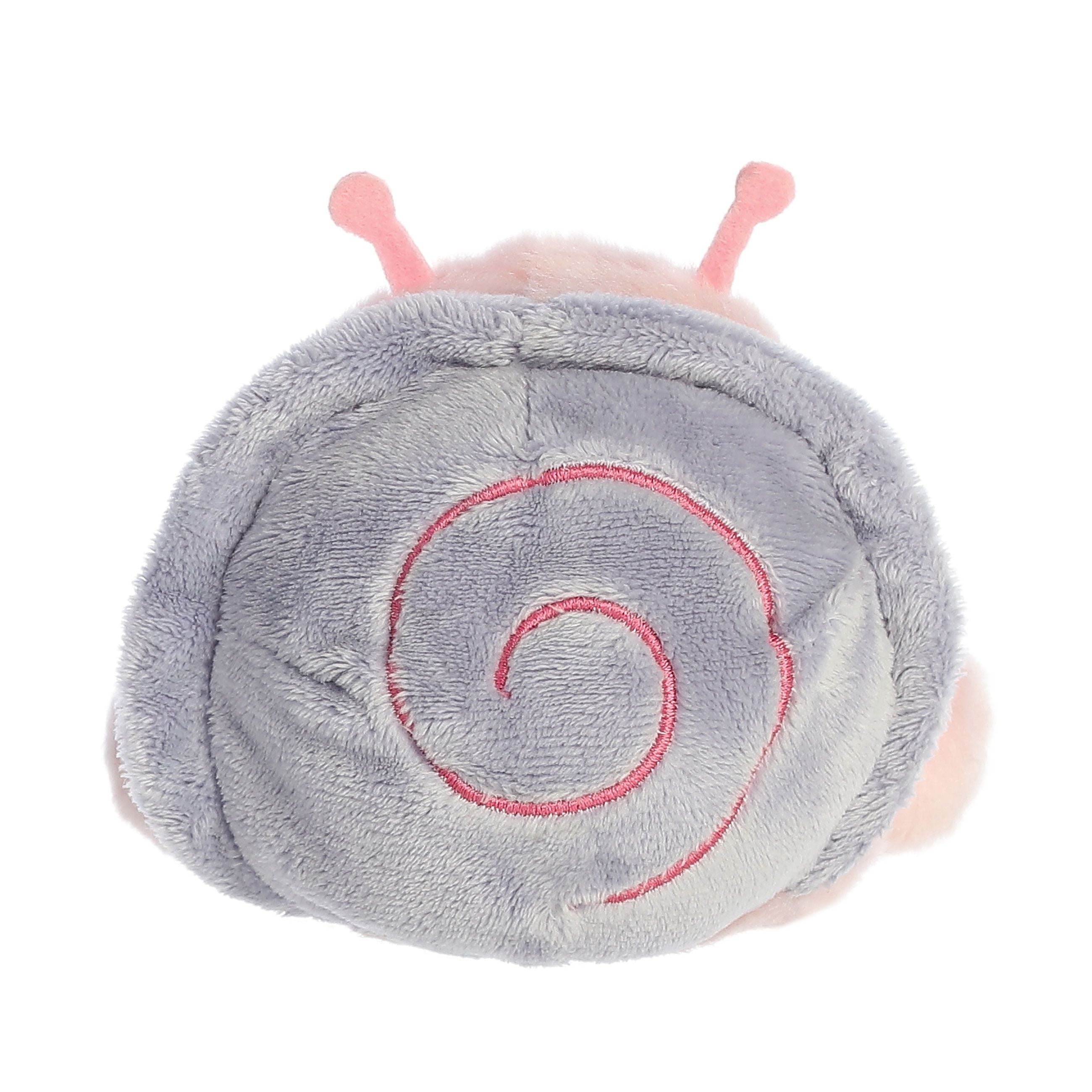 The Twice as Sweet Palm Pal Shelby Snail is a soft, plush toy with a light purple shell, pink swirl pattern, and two pink antennae—perfect for cozy companionship.
