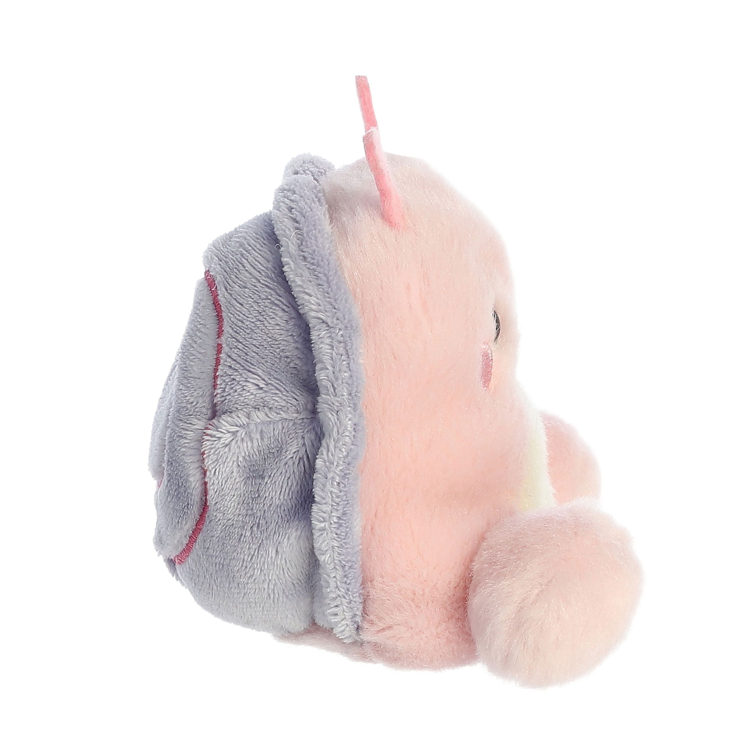 A side view of the Palm Pal Shelby Snail by Twice as Sweet, a soft pink snail plush with a gray shell and small pink antennae, is displayed against a white background.