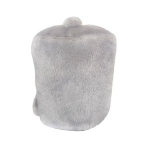 The Palm Pal Garbanzo Trashcan by Twice as Sweet is a cylindrical, light gray fur hat with a rounded top and small pom-pom, resembling a plush figure, shown against a white background.